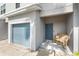 Inviting front entry with a cozy bench, blue door, and a well-maintained garage at 4644 Vignette Way, Sarasota, FL 34240