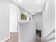 Upstairs hallway showcasing natural light and neutral paint, leading to bedrooms at 4644 Vignette Way, Sarasota, FL 34240