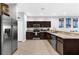 Modern kitchen with stainless steel appliances, dark wood cabinets, and plenty of counter space at 4644 Vignette Way, Sarasota, FL 34240