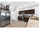 Modern kitchen with stainless steel appliances, dark cabinets, and ample counter space for cooking at 4644 Vignette Way, Sarasota, FL 34240