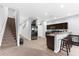 Spacious open-concept kitchen with modern appliances, breakfast bar, and tile flooring at 4644 Vignette Way, Sarasota, FL 34240