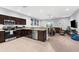Open-concept kitchen flowing into the living room, stainless appliances, and dark wood cabinets at 4644 Vignette Way, Sarasota, FL 34240