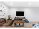 Comfortable living room featuring a large TV, plush sofa, and stylish decor for relaxing evenings at 4644 Vignette Way, Sarasota, FL 34240