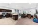 Open-concept living area with kitchen, dining space, plush seating, and a neutral color scheme at 4644 Vignette Way, Sarasota, FL 34240