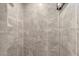 Close up of renovated shower with decorative band and neutral tiling at 4644 Vignette Way, Sarasota, FL 34240