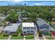 Aerial view of the home surrounded by lush trees with city view in the distance at 480 28Th N Ave, St Petersburg, FL 33704