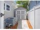 Side yard with AC unit and a pathway to a gray storage shed at 480 28Th N Ave, St Petersburg, FL 33704