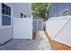 Side yard with paved pathway leading to a gray storage shed at 480 28Th N Ave, St Petersburg, FL 33704