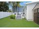 Backyard boasts gray wood deck, lush greenery, and storage shed at 480 28Th N Ave, St Petersburg, FL 33704