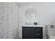 Bathroom featuring a modern vanity, elegant mirror, and shower with decorative curtain at 480 28Th N Ave, St Petersburg, FL 33704