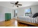 Bright bedroom featuring hardwood floors, striped bedding, and a vintage green dresser at 480 28Th N Ave, St Petersburg, FL 33704