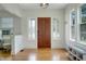 Bright foyer featuring a beautiful wooden door, complemented by pristine hardwood floors and natural light at 480 28Th N Ave, St Petersburg, FL 33704