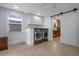 Spacious laundry room with modern washer and dryer set and white shaker cabinets at 480 28Th N Ave, St Petersburg, FL 33704