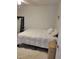 Simple bedroom setup with a comfortable bed, minimal decor, and natural light at 4835 Winslow Beacon # 46, Sarasota, FL 34235