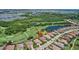Aerial view of a beautiful home backing onto a lush green golf course surrounded by mature trees and water features at 4931 Benito Ct, Bradenton, FL 34211
