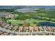 A scenic aerial view highlights a home near a lush golf course, ponds, and luxurious community amenities at 4931 Benito Ct, Bradenton, FL 34211