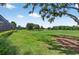 Enjoy serene golf course views from this backyard with lush greenery, complemented by beautiful trees and blue sky at 4931 Benito Ct, Bradenton, FL 34211