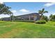 A lush backyard features verdant lawn, a screened-in lanai, and tropical landscaping providing outdoor living at 4931 Benito Ct, Bradenton, FL 34211