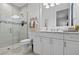 Bright bathroom featuring a glass-enclosed shower and a well-lit vanity with a stylish mirror at 4931 Benito Ct, Bradenton, FL 34211