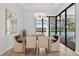 Elegant dining room with a view of the pool, stylish light fixture, and comfortable seating at 4931 Benito Ct, Bradenton, FL 34211