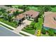 Beautiful home with lush landscaping, a paver driveway, and a charming entrance, adjacent to a golf course at 4931 Benito Ct, Bradenton, FL 34211