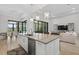 Open concept kitchen with a large island, stainless steel dishwasher, and an open view to the living room at 4931 Benito Ct, Bradenton, FL 34211