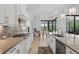Modern kitchen with stainless steel appliances, a tile backsplash, and an adjacent dining area at 4931 Benito Ct, Bradenton, FL 34211