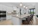 Bright, airy kitchen with a large center island, stainless appliances, and stylish pendant lighting at 4931 Benito Ct, Bradenton, FL 34211