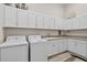 Bright laundry room with new appliances, granite counters, and ample cabinet space at 4931 Benito Ct, Bradenton, FL 34211