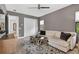 Inviting living room features a plush sofa, area rug, and a view of the yard at 4931 Benito Ct, Bradenton, FL 34211