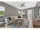 Stylish living room features a comfortable sofa, area rug, ceiling fan and plenty of natural light at 4931 Benito Ct, Bradenton, FL 34211