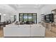Bright open living room with large sliding glass doors overlooking the outdoor pool and entertainment area at 4931 Benito Ct, Bradenton, FL 34211