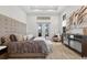 This primary bedroom features a tray ceiling, French doors, and a decorative dresser at 4931 Benito Ct, Bradenton, FL 34211