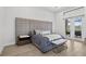 This spacious primary bedroom features a large padded headboard and french doors at 4931 Benito Ct, Bradenton, FL 34211