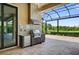 Outdoor kitchen featuring a stainless steel grill, granite countertop, and screened lanai at 4931 Benito Ct, Bradenton, FL 34211