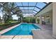 A screened-in pool with an attached spa provides a serene outdoor retreat at 4931 Benito Ct, Bradenton, FL 34211