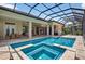 A screened-in pool with an attached spa provides a serene outdoor retreat at 4931 Benito Ct, Bradenton, FL 34211