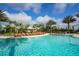 Beautiful pool area with comfortable lounge chairs and lush tropical landscaping at 4931 Benito Ct, Bradenton, FL 34211