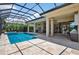 Screened lanai offers a swimming pool and spa with outdoor living and dining spaces at 4931 Benito Ct, Bradenton, FL 34211