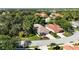 Aerial view of the property showcasing its well-manicured landscaping and tile roof in a lush, green neighborhood at 5018 Hanging Moss Ln, Sarasota, FL 34238