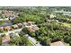 Beautiful aerial view of houses in a lush, green community with a lake nearby at 5018 Hanging Moss Ln, Sarasota, FL 34238