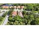 Aerial view of beautiful homes with orange tile roofs nestled among lush green trees at 5018 Hanging Moss Ln, Sarasota, FL 34238