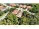 An aerial view of homes among lush trees and landscaping and adjacent to a pond at 5018 Hanging Moss Ln, Sarasota, FL 34238