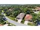 Aerial view of the house featuring a tile roof, manicured landscaping, and proximity to mature trees and neighborhood streets at 5018 Hanging Moss Ln, Sarasota, FL 34238