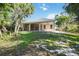 Expansive backyard with a screened-in lanai, offering a relaxing outdoor living space surrounded by lush landscaping at 5018 Hanging Moss Ln, Sarasota, FL 34238