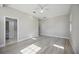 Bright bedroom featuring wood-look tile floors and ensuite bathroom access at 5018 Hanging Moss Ln, Sarasota, FL 34238