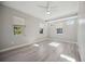 Sunny bedroom with beautiful wood-look tile flooring and bright windows at 5018 Hanging Moss Ln, Sarasota, FL 34238