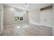 Bright bedroom with wood-look tile flooring, large window, and a ceiling fan at 5018 Hanging Moss Ln, Sarasota, FL 34238