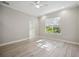 A bright bedroom featuring wood-look tile flooring and a view of the bathroom at 5018 Hanging Moss Ln, Sarasota, FL 34238