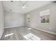 Well-lit bedroom with wood-look floors, white trim and two large windows at 5018 Hanging Moss Ln, Sarasota, FL 34238
